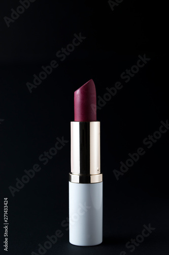 red lipstick isolated on black background