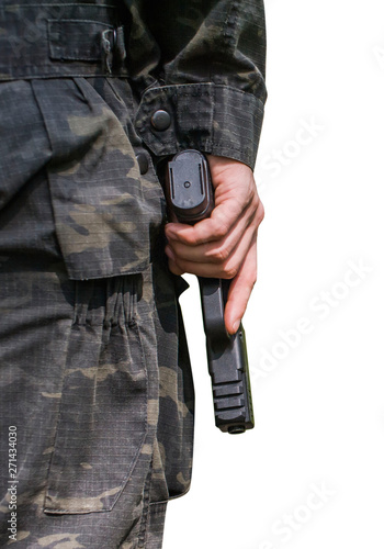 A man in military clothes holds a pistol in his hand. Close-up on a white background. Rear view. © Александр Довянский