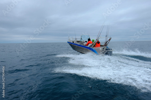 a group of fishermen are sailing in a motorboat
