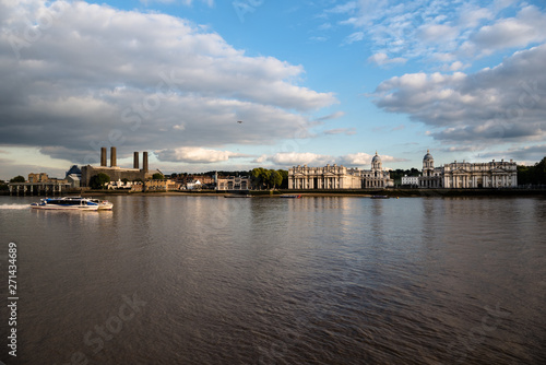 Thames River commuter ferry passing Greenwich riverfront buildings © Magnus