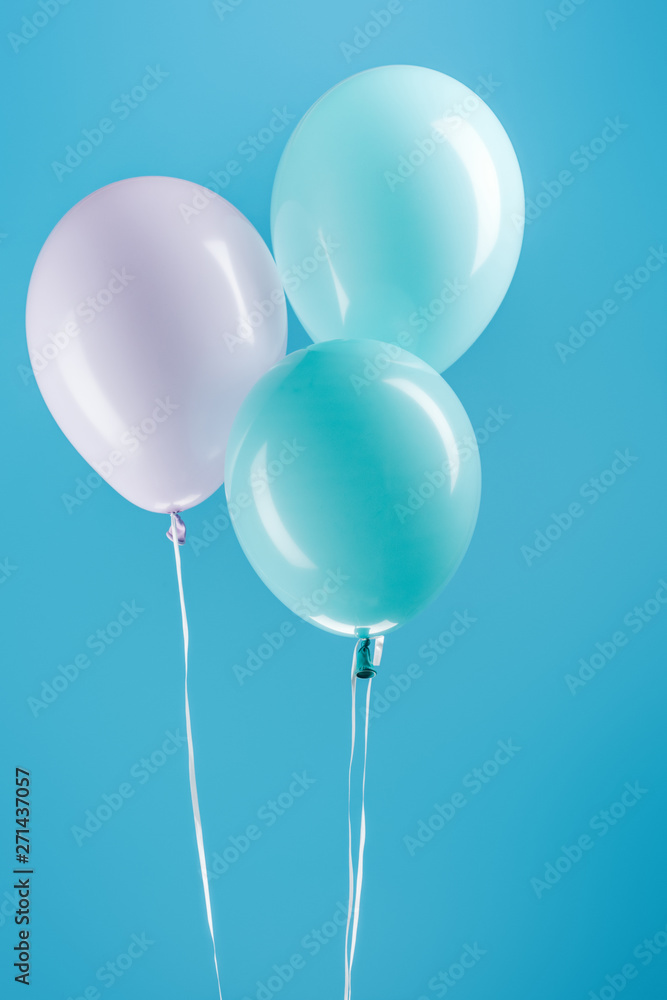 purple and blue festive balloons on blue background purple and blue festive balloons on blue background