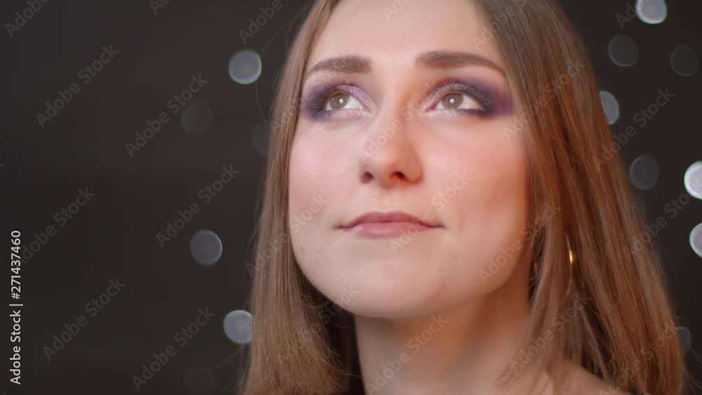 Closeup portrait of young beautiful caucasian girl looking at camera and smiling with bokeh background Closeup portrait of young beautiful caucasian girl looking at camera and smiling with bokeh background