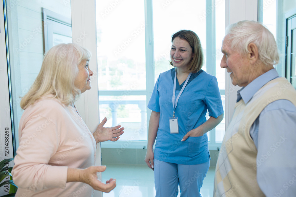 Fototapeta premium Nurse talking with senior people in retirement home.