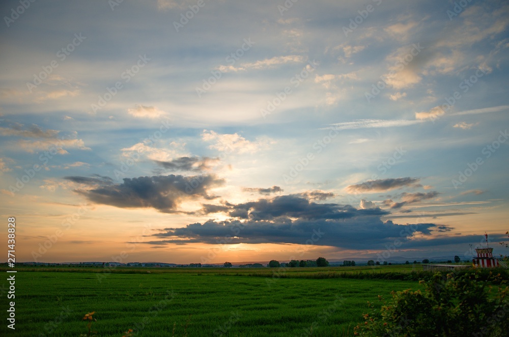 sunset over green field sunset over green field