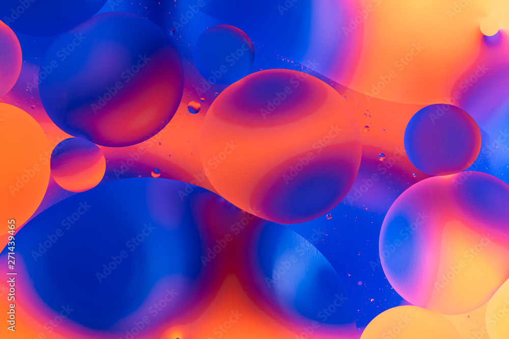 Fototapeta oily drops in water with colorful background, close-up