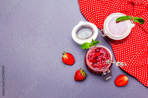 Strawberry jam in a glass jar.