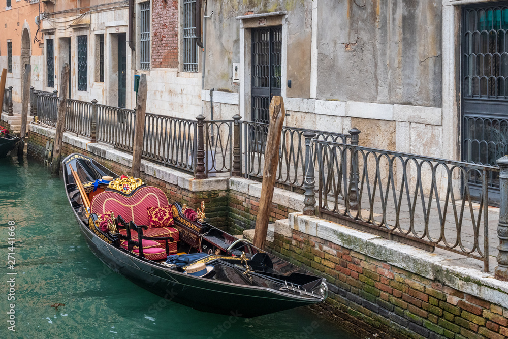 Rich decorated gondola on the quay in Venezia, Italy