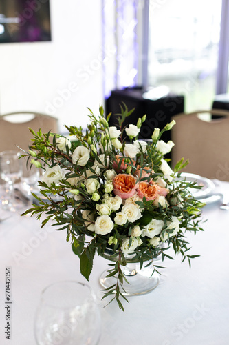 The composition of fresh flowers on the table. The decor of the Banquet in the restaurant flowers. Selective focus.
