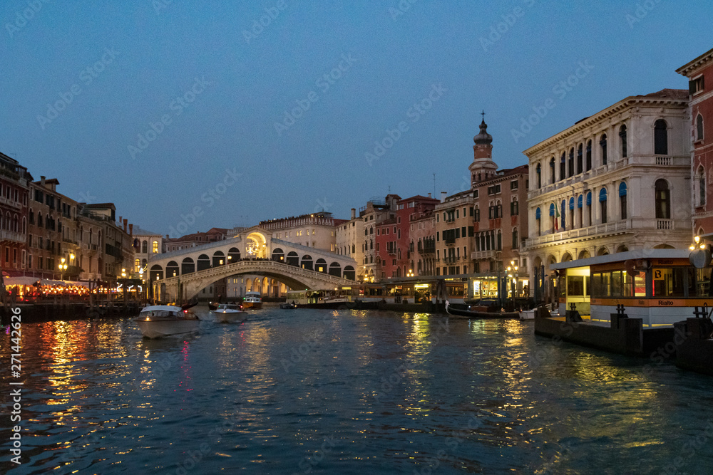 View of Grand Canal in winter's night with crowd on the Rialto bridge