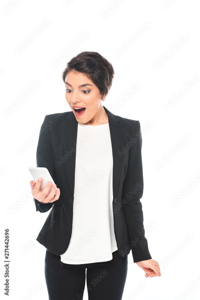 excited mixed race businesswoman in black formal wear looking at smartphone isolated on white excited mixed race businesswoman in black formal wear looking at smartphone isolated on white