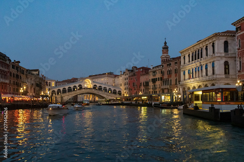 View of Grand Canal in winter's night with crowd on the Rialto bridge