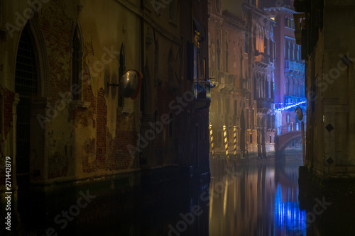 Reflection of streetlights in one of canals in Venezia, Italy