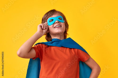 Confident superhero adjusting mask