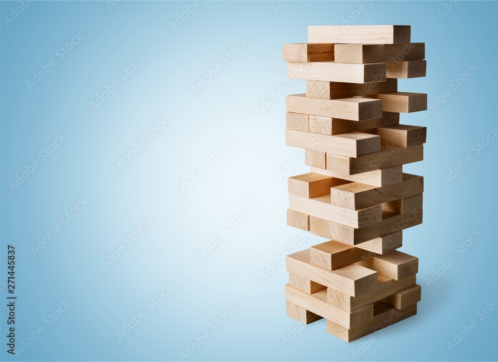 Wood blocks stack game with Hand on background,Conceptual of Teamwork, Strategy and Vision. Wood blocks stack game with Hand on background,Conceptual of Teamwork, Strategy and Vision.