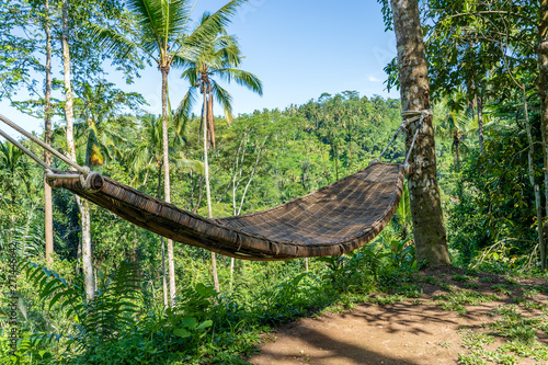 Bamboo wicker hammock next to the tropical jungle in island Bali, Indonesia