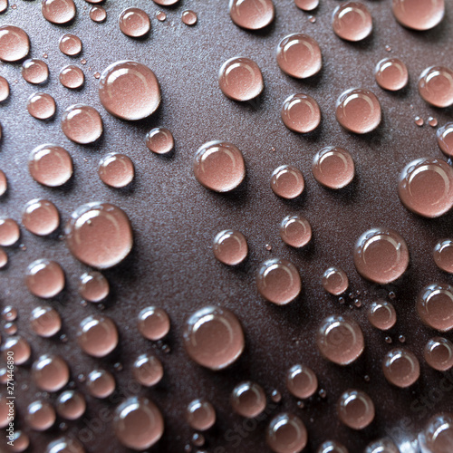 Drops of water on the brown plastic texture, macro