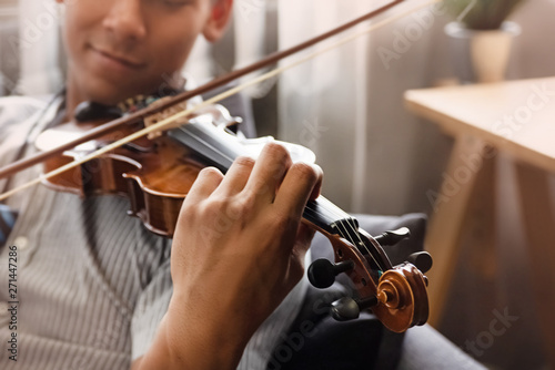 Принти на полотні In selective focus of human hand pressing on string,show how to play violin,blur