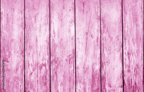 Weathered wooden fence in pink color.