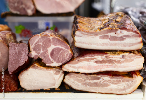 Variety of smoked and fried meat products. Traditional marketplace.