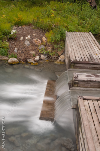 A portrait aspect of a long exposure of water tumbling down a step at the Liard Hot Springs, British Columbia, Canada, nobody in the image © Wise Dog Studios
