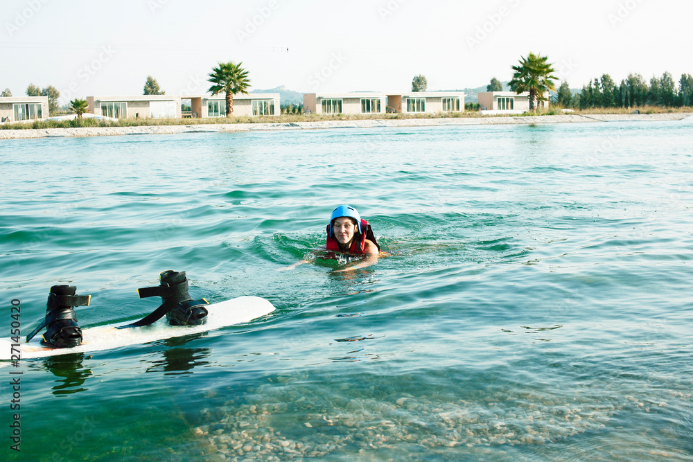 young smiling girl on wake board in water, happy lifestyle people on vacations