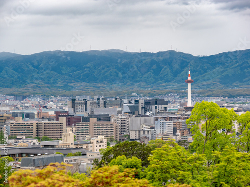 Panoramic Cityscape overview of Kyoto, Japan. Mountains and rainy sky at the background