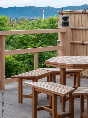 Wooden balcony and bench at cafe with scenic view of mountain and forest in Kyoto  Japan