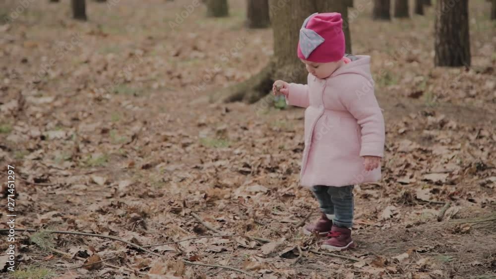 Beautiful little girl walking alone in the forest. Beautiful little girl walking alone in the forest.