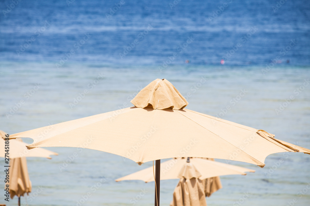 Relaxing Beach background with umbrellas and sea 