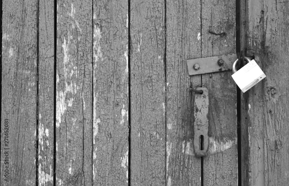 Old padlock on wooden gate in black and white. Old padlock on wooden gate in black and white.