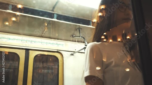 The doors of the subway car close in front of the girl close-up.