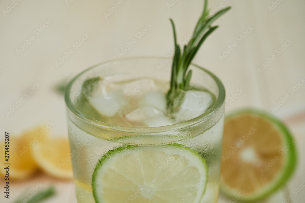 Refreshing Summer Cocktail with Citrus Fruits and rosemary on a Wooden Table , close-up Refreshing Summer Cocktail with Citrus Fruits and rosemary on a Wooden Table , close-up