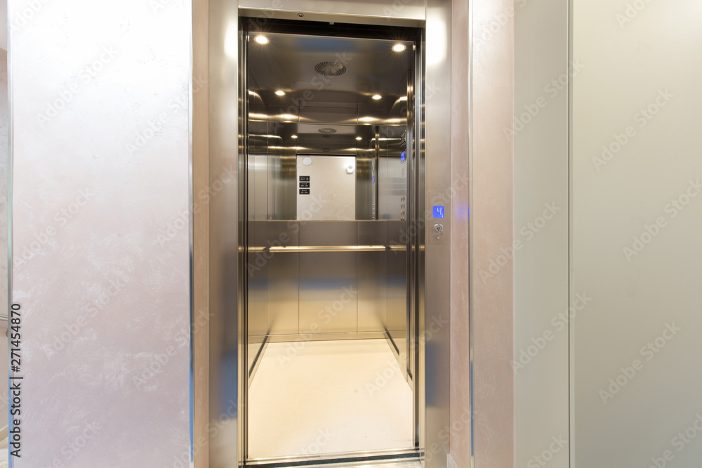 Hotel corridor with open elevator door
