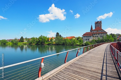 Wooden footbridge over Aare river, view of Aarwangen Castle, Canton Berne, Switzerland. Idyllic scene.