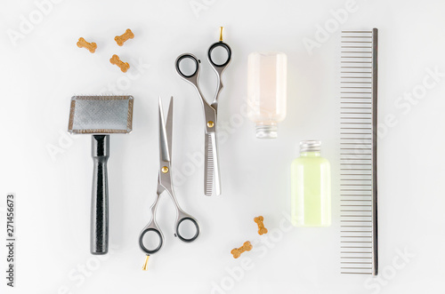 grooming tools, scissors, brush, comb, shampoo and dog treats, flat lay