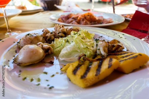 Mixed grilled seafood in Venezia, Italy with polenta