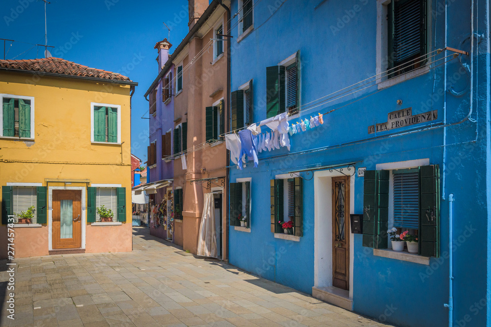 Colorful street in Burano, Venezia, Italy with some clothes drying