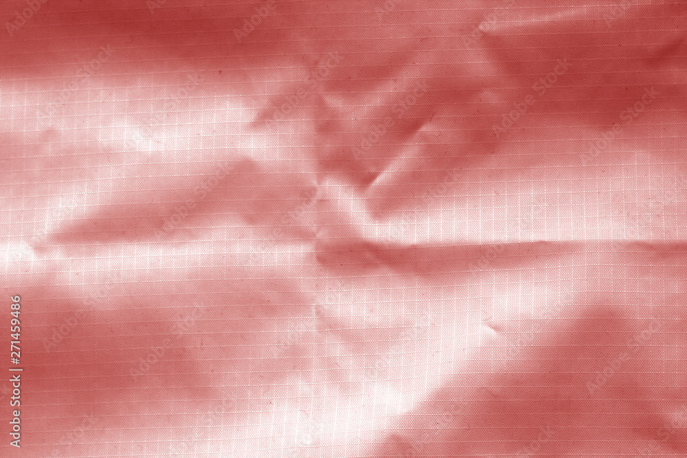 Crumpled transparent plastic surface in red color. Crumpled transparent plastic surface in red color.