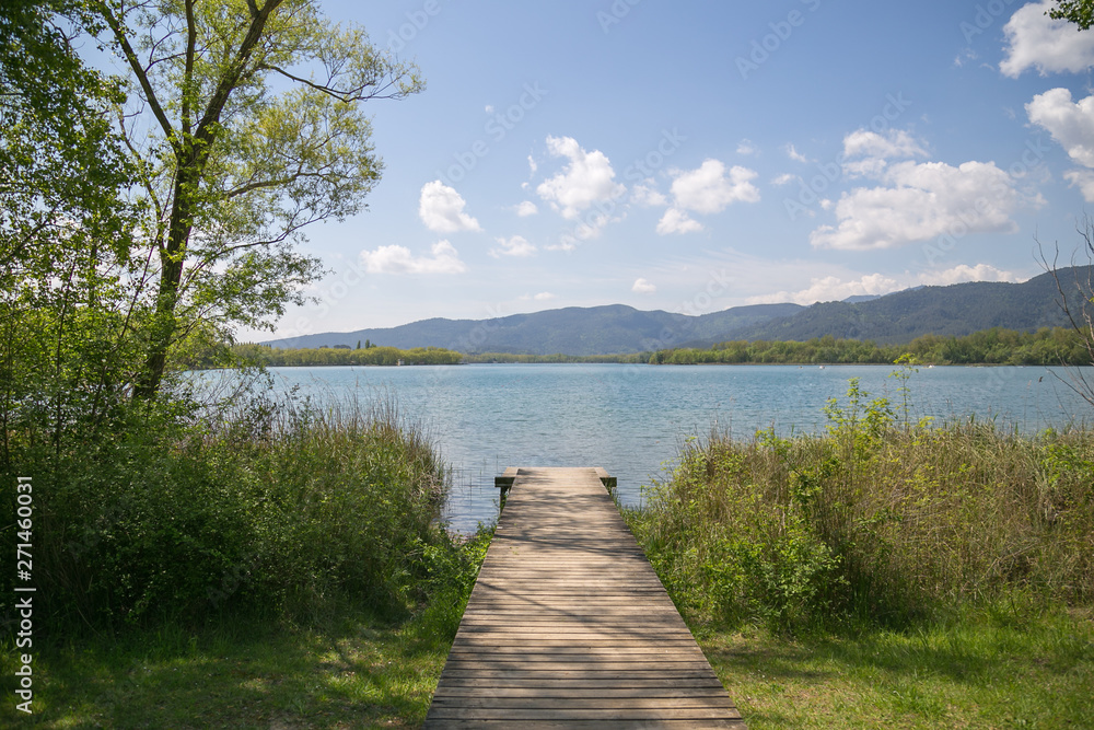 Wooden pathway and jetty in the lake.