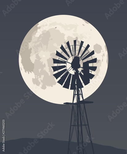 Wind pump on the background of the night sky and the full moon