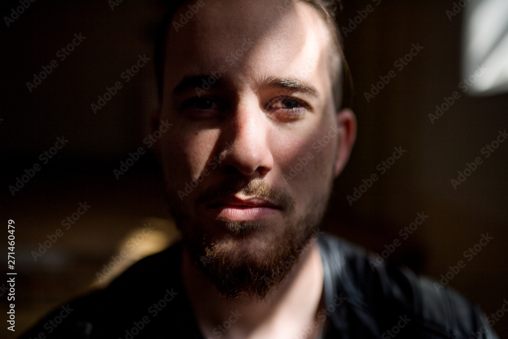 A portrait of young man indoors, a close-up. A portrait of young man indoors, a close-up.