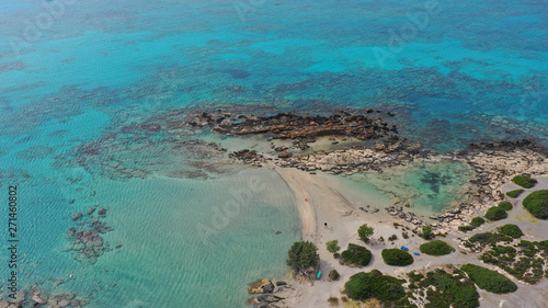 Aerial top view photo of men practising wind surfing in exotic paradise open ocean bay with crystal clear turquoise sea