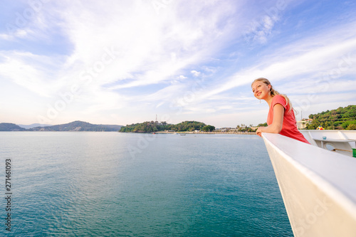 Voyage or cruise. Pretty young woman enjoying view on ship deck. Sailing the sea.