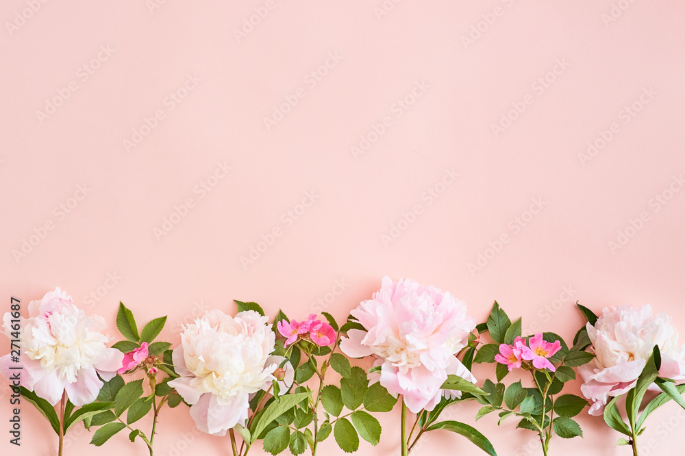 Flat lay composition with pink peonies on a pink background Flat lay composition with pink peonies on a pink background