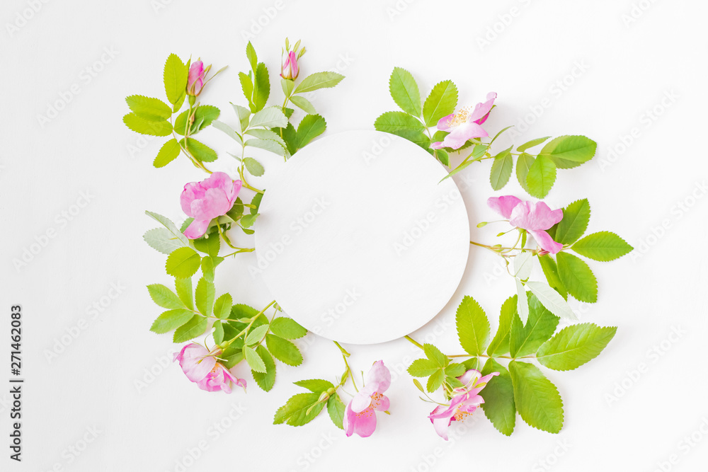 Mockup round white frame with pink flowers on white background Mockup round white frame with pink flowers on white background