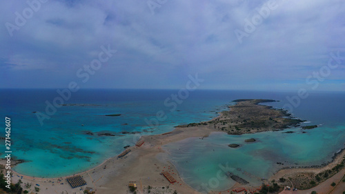 Fototapeta Naklejka Na Ścianę i Meble -  Aerial top view photo of men practising wind surfing in exotic paradise open ocean bay with crystal clear turquoise sea