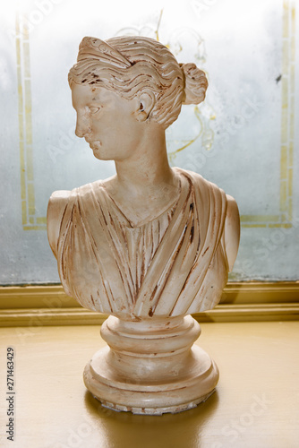 Reproduction Italian marble bust of the goddess Tyche Signe Umberto Frilli, with her head turned and wearing her distinctive tiara. This is a replica of the classic Roman statue. photo