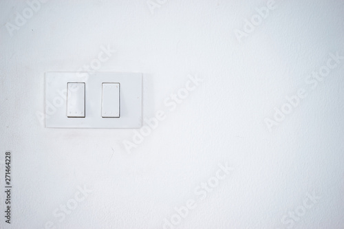 Double electrical switch control on the white wall.