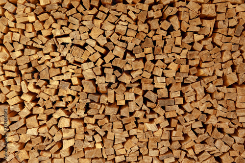 The texture of wooden firewood, randomly split and laid in straight rows