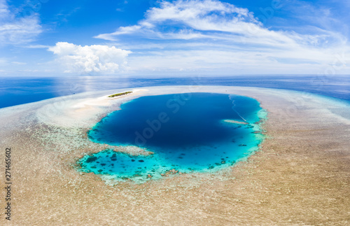 Fototapeta Naklejka Na Ścianę i Meble -  Aerial: tropical atoll view from above, blue lagoon turquoise water coral reef, Wakatobi Marine National Park, Indonesia - concept travel destination Maldives Polinesia
